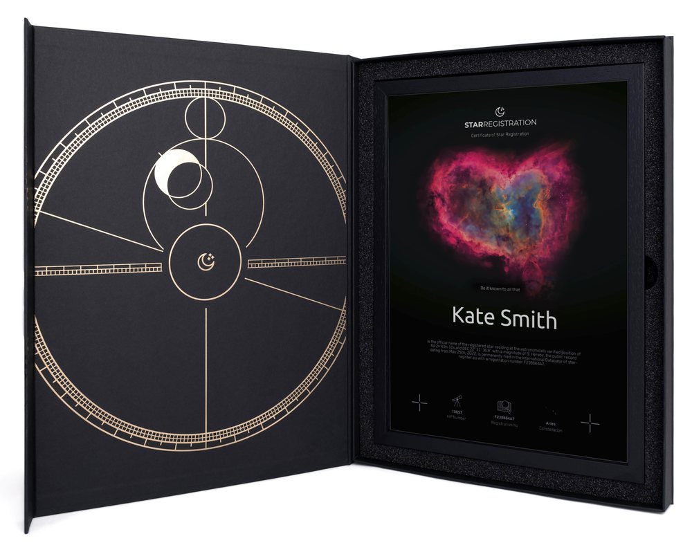 The black-and-gold gift box, open, with a framed heart nebula star certificate for Kate Smith inside